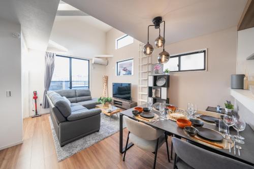 a dining room and living room with a table and chairs at Boasorte Urayasu in Tokyo