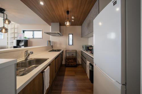 a kitchen with a sink and a counter top at Boasorte Urayasu in Tokyo