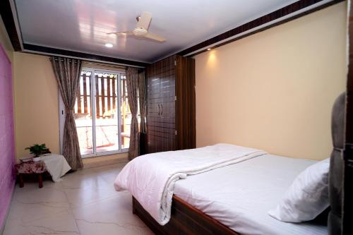 a bedroom with a large bed and a window at Malama Stay The Dusk Villa 3BHK Lonavala in Lonavala
