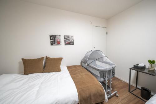 a bedroom with a hospital bed with a stroller at Boasorte Urayasu in Tokyo