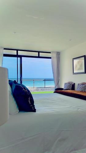 a bedroom with a bed with a view of the ocean at Simla Luxury Apartments 11 in Margate