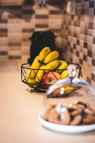 a plate of fruit and a basket of bananas at Alexi's House in Kalavrita
