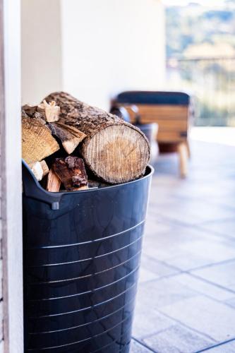 a black bucket filled with fire wood at Alexi's House in Kalavrita