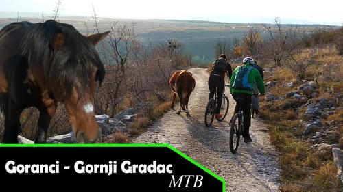 two people on bikes and a horse on a trail at Kuća za odmor Bela Goranci in Mostar