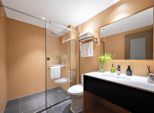 a bathroom with a toilet and a sink and a shower at Beijing Tangfu Nanluoguxiang Wang Fu Jing Forbidden City Snack Street Hotel,1 stop walking to airport express,3 stop to tiananmen&Free Laundry Dry Service and Free Afternoon Tea &professional Free Tour Ticket Service with English Speaking Staff in Beijing