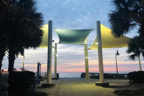 a view of a building with palm trees and the ocean at Stunning Ocean Front OO Resort 7th Floor 2 Bdr in Myrtle Beach