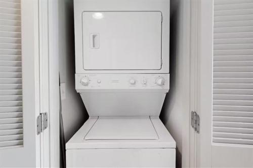 a small white refrigerator in a white closet at Stunning Ocean Front OO Resort 7th Floor 2 Bdr in Myrtle Beach
