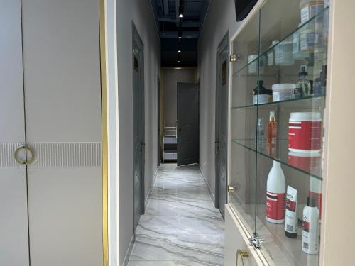 a corridor with glass shelves in a hallway at Modern апарт-отель, напротив Ботанического Сада in Astana