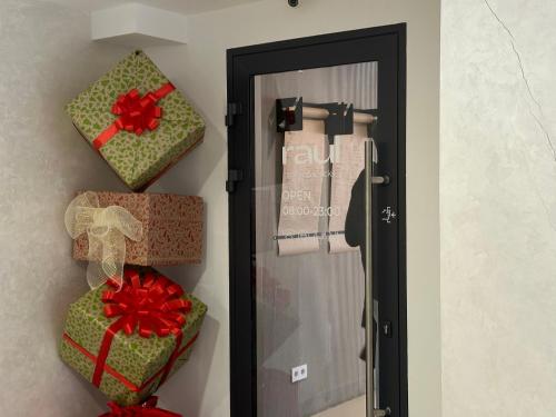 a door with three presents on the wall at Modern апарт-отель, напротив Ботанического Сада in Astana