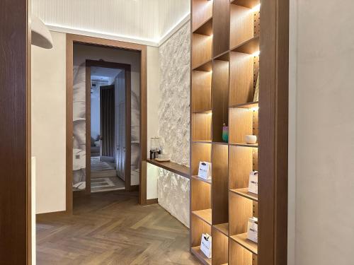 a room with a hallway with wooden shelves at Y'estoria апарт-отель, район EXPO центра in Astana