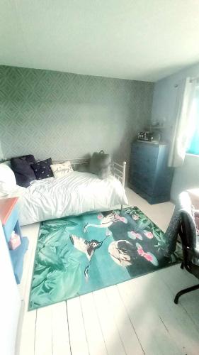 a bedroom with a bed with a blanket on the floor at No21 StMartins in Ifton Heath