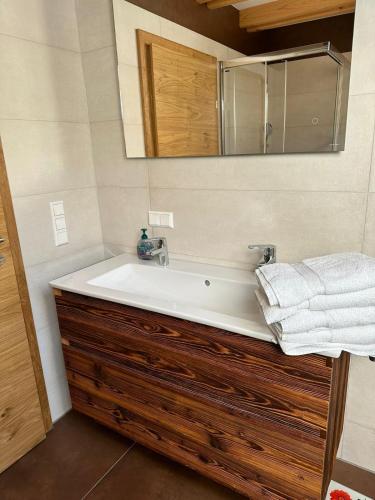 a bathroom with a white sink and a mirror at Siedls Enzian in Hirschegg Rein
