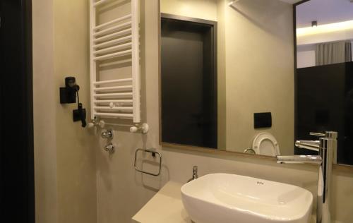 a bathroom with a white sink and a mirror at Keta Hotel & Spa - Mavrovo in Mavrovo