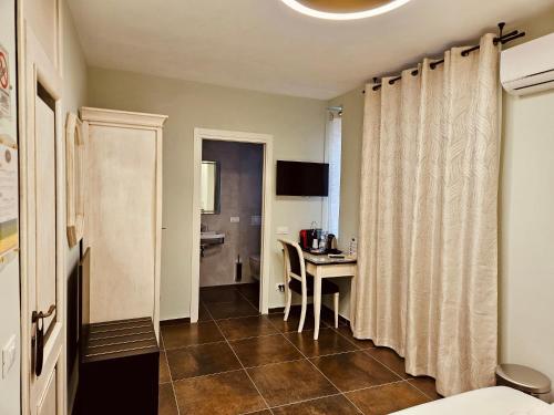 a small room with a table and a kitchen at Ai Poeti in Brescia