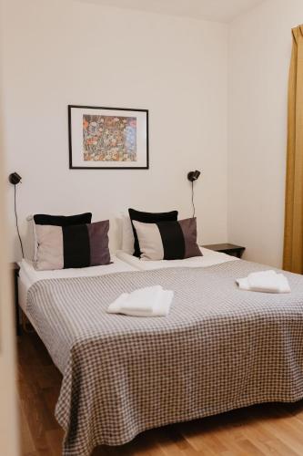 a bedroom with a large bed with two pillows on it at Vassbo Vandrarhem in Falun
