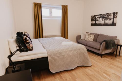 a bedroom with a bed and a couch at Vassbo Vandrarhem in Falun