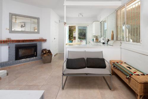 a living room with a chair and a fireplace at Finca Carrion in Periana
