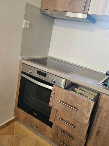 a kitchen with a stove top oven in a kitchen at STUDIO Θαλλώ Thallo in Galaxidhion