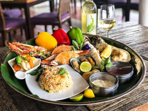 a tray of food on top of a table at Aleenta Hua Hin - Pranburi - The Small Luxury Hotels of the World in Pran Buri