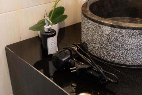 a camera on a counter next to a bath tub at Weda Villas in Ubud