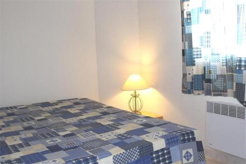 - une chambre avec un lit et une lampe à côté dans l'établissement Maison 3 pièces - Gruissan GA090-056, à Gruissan