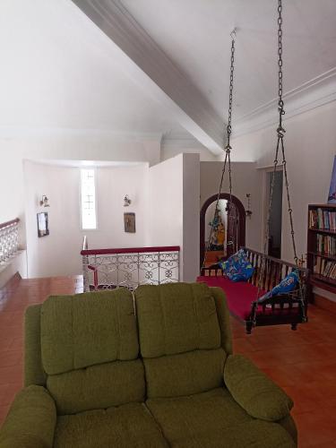 a living room with a couch and a swing at Riverside Group in Kakkanad