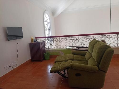 a living room with a couch and a tv at Riverside Group in Kakkanad