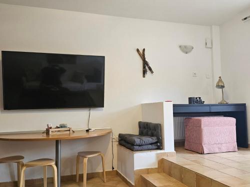 a living room with a large flat screen tv on the wall at STUDIO Θαλλώ Thallo in Galaxidhion