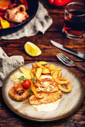 a plate of food on a wooden table at Keta Hotel & Spa - Mavrovo in Mavrovo
