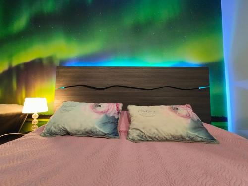 a bedroom with a bed with two pillows on it at Northern Lights - Cozy apartment, sisältää liinavaatteet in Kalajoki