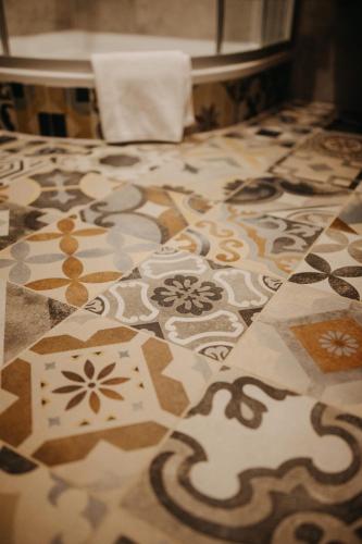 a tile floor with flowers on it in a room at Hotel Alpin Tyrol - Kitzbüheler Alpen in Sankt Johann in Tirol