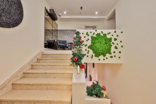 a staircase in a house with christmas decorations at Hotel Botanica in Belgrade