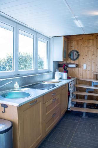 - une cuisine avec deux lavabos et deux fenêtres dans l'établissement Ker Tambac - vue mer - wifi, à Camaret-sur-Mer