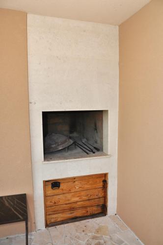 a fireplace in the corner of a room at Kuća za odmor Bela Goranci in Mostar