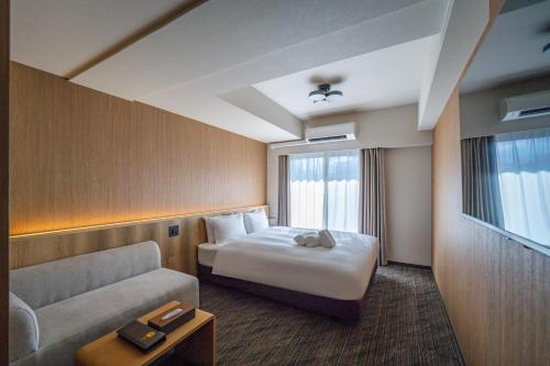 Postel nebo postele na pokoji v ubytování Apartment Hotel 11 Namba Minami 4