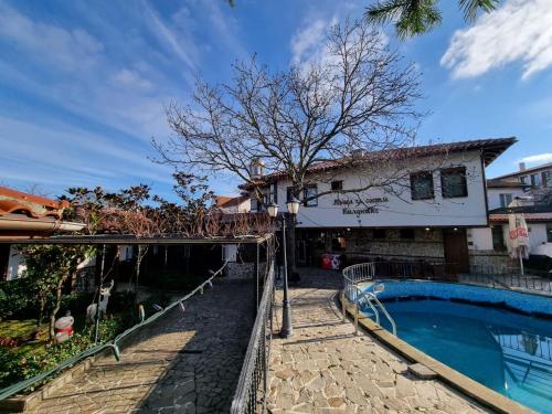 a house with a swimming pool next to a building at Къща за гости Билдникс in Malko Tŭrnovo