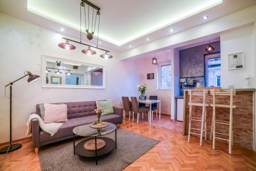 a living room with a couch and a table at Panorama Central Apartments in Belgrade