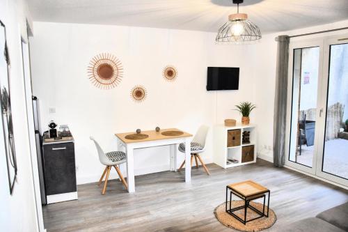 a living room with a table and chairs at Élégant studio Gréoux Les Bains in Gréoux-les-Bains