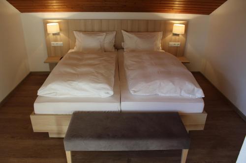 two beds in a small room with a table at Gasthof und Pension zum Löwen in Hirschberg an der Bergstraße