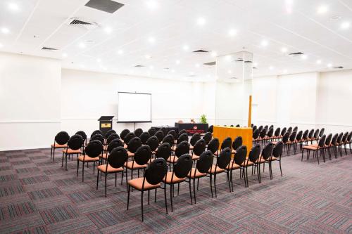 a conference room with chairs and a podium at Metro Hotel Marlow Sydney Central in Sydney