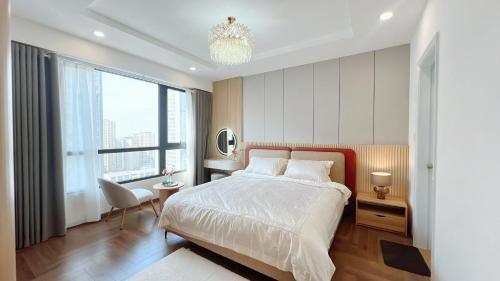 a bedroom with a bed and a large window at KABILUX HOUSE - 1-2-3 Bedrooms in Vinhomes Times City in Hanoi