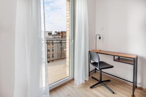 an office with a desk and a view of a balcony at Hock Residence by Vagabond in Budapest