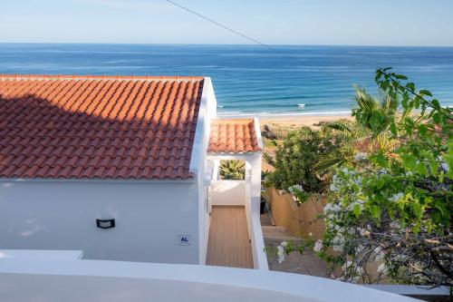 a white house with a view of the ocean at Porto Santo Precious Oceanview in Campo de Baixo