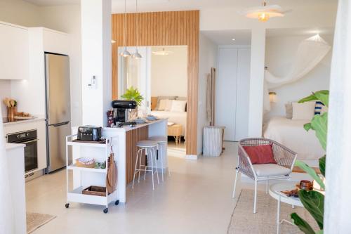 a living room with a kitchen and a room with a bed at Porto Santo Precious Oceanview in Campo de Baixo