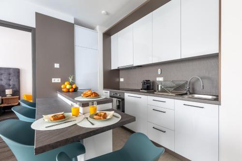 a kitchen with two plates of food on a counter at Hock Residence by Vagabond in Budapest