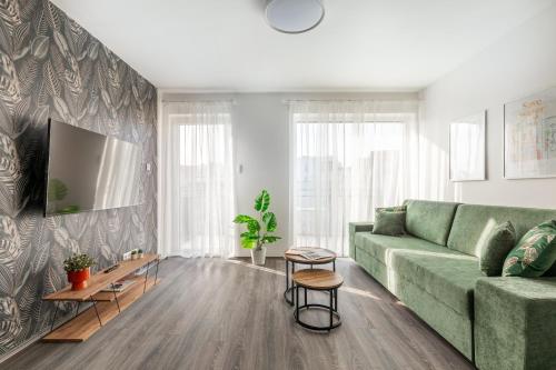 a living room with a green couch at Hock Residence by Vagabond in Budapest