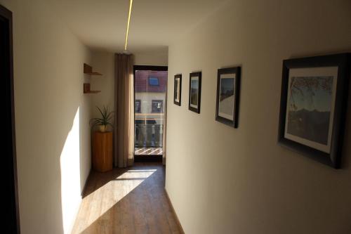 a hallway with pictures on the walls of a house at Gasthof und Pension zum Löwen in Hirschberg an der Bergstraße