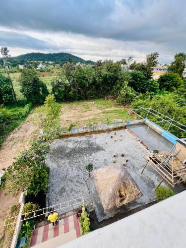 an aerial view of a garden with an umbrella at Coorg Dreamland Homestay Entire in Kushālnagar