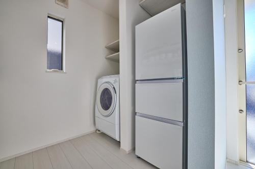 a laundry room with a washer and dryer at MIYA HOUSE Funatsu A in Fujikawaguchiko