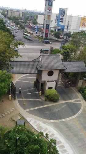 a small building with a roof on a street at The Redwoods SM Fairview with Balcony in Manila